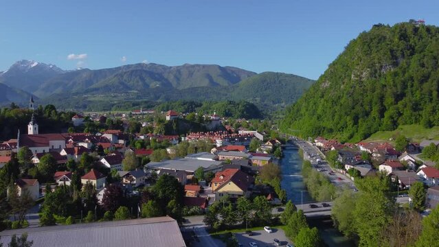 Drone Zooming In Video Clip Of A Beautiful European Town With Lush Green Mountain Landscape River And Road in Kamnik, Slovenia