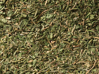 Background Texture of dried parsley. Surface covered with dried parsley as a backdrop. Parsley spice texture.  Top view, Flat lay. Organic food, healthy lifestyle

