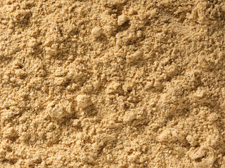 Ginger root powder condiment background, used as a spice in cooking. Pile of ginger ground or dried plant powder. tasty dried ginger spice. Organic food, healthy lifestyle. Top view, Flat lay