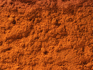 Background texture of chili pepper powder spice used as a spice in cooking. Pile of chili pepper. Organic and tasty dried chili pepper spice. Organic food, healthy lifestyle. Top view, Flat lay
