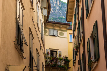 Fototapeta na wymiar Residential houses in the Italian town of Riva del Garda on Lake Garda under blue sky and light clouds