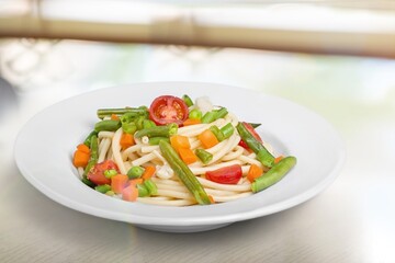 Mix corn pasta with chees and vegetable on plate.