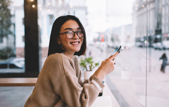 Young Millennial Asian Girl Resting In Cafe