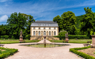Fototapeta na wymiar historic high school Lyceum building and gardens with fountain and statues in Echternach