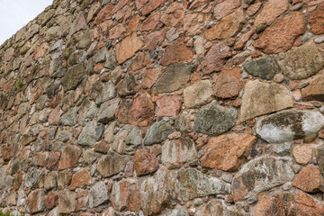 Close up view of natural nature stone wall texture on sky background. Sweden.