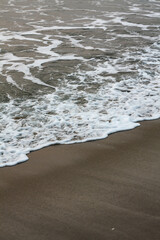 Bubbles on golden beach with ocean water in the morning at Thailand beaches.