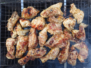 Roasted chicken wings on barbecue. Top view.