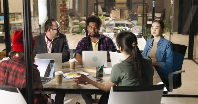 Diverse multiethnic programmers or developers on brainstorming session. Teamwork of different people in new startup 4k footage