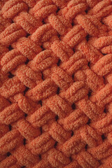 Plush plaid. Soft yarn for knitting. Cozy knitted background. Knit by hand. Home comfort. Handmade product. Women's hobby. Yarn texture.