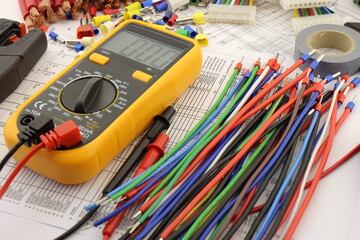 Multimeter and tools for installing an electrical control panel in close-up on an electrical...