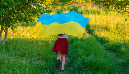 Child with Ukrainian flag patriot stop war. Selective focus.