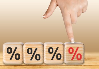 Human hand choosing increasing percent  on wooden cubes.