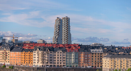Evening view of roofs and dorms of buildings and the skyscrapers Twin Tower in the district Vasa Stan a sunny summer day in Stockholm - obrazy, fototapety, plakaty
