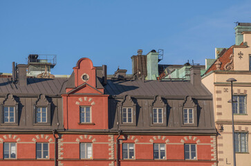 Details of facades on old 1700s houses in the old town Gamla Stan an evening sunny summer day in Stockholm