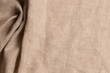 Texture old brown linen canvas fabric. Natural organic eco textiles burlap, grungy rustic cloth material background. Crumpled wrinkled material. Top view