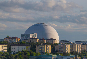 Evening sun over the arena Globen, Davicii, and apartment buildings in the district Hammarby a summer day in Stockholm