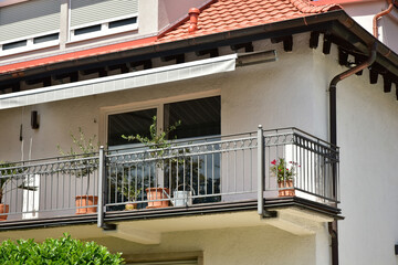 Moderner Balkon mit beschichtetem Metall-Geländer an Neubau-Hausfront