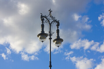 Fototapeta na wymiar Old light poles against a blue sky