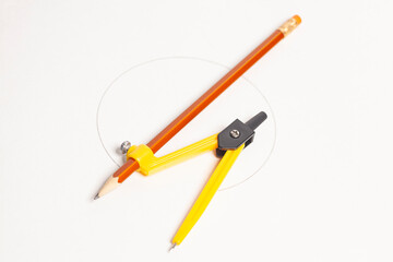 Yellow compass with pencil isolated on white background