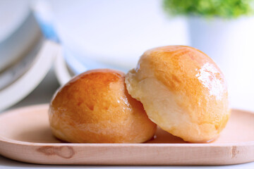 Two butter bread bun  on wooden plate with book