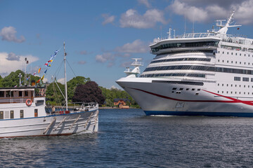 Fototapeta premium Old steam boat and cruise ship meet in the harbor a sunny day in Stockholm