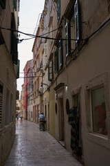 Fototapeta premium Sibenik, Croatia - May 26, 2022 - narrow old street and yard in Sibenik city, medieval zone