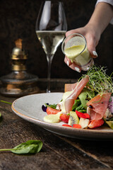 Salad with strawberries, parmesan and prosciutto. 