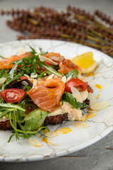 Salad with salmon, caviar, herbs, cherries