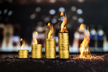 Expensive Energy Crisis Concept. Golden stack coins with flame.