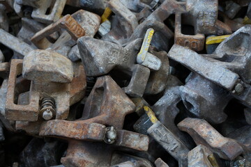 Close up view on automatic twist Locks piled in lashing bin situated on the container vessel. Twistlocks are using for securing of containers on deck of the ship.