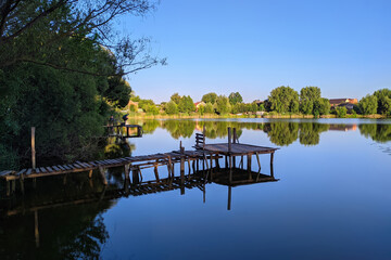 wooden pontoon for fishermen on the lake