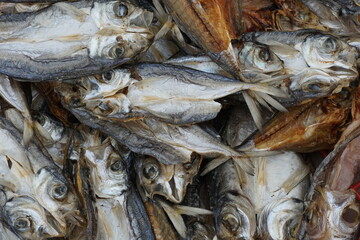Close up view on dry fishes without offal piled in box.  It is traditional Asian food style. 