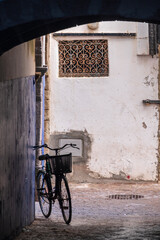 bicycle silhouette under the arches of the medina , Essaouira, morocco, africa