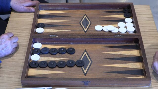 Two old men playing an exotic version of backgammon in a caf&eacute; in Chania, Greece, on April 8 2022.