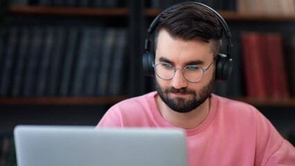 Latino man in headphones talking online video call remotely conference distance education use laptop