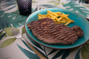 Grilled steak and fried potatoes ready to eat.