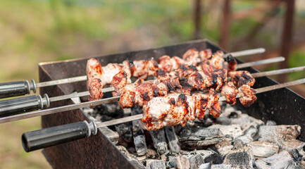 Marinated shashlik preparing on a barbecue grill over charcoal. Shashlik or Shish kebab popular in Eastern Europe