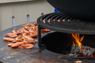 Cooking shrimp on the grill with fire