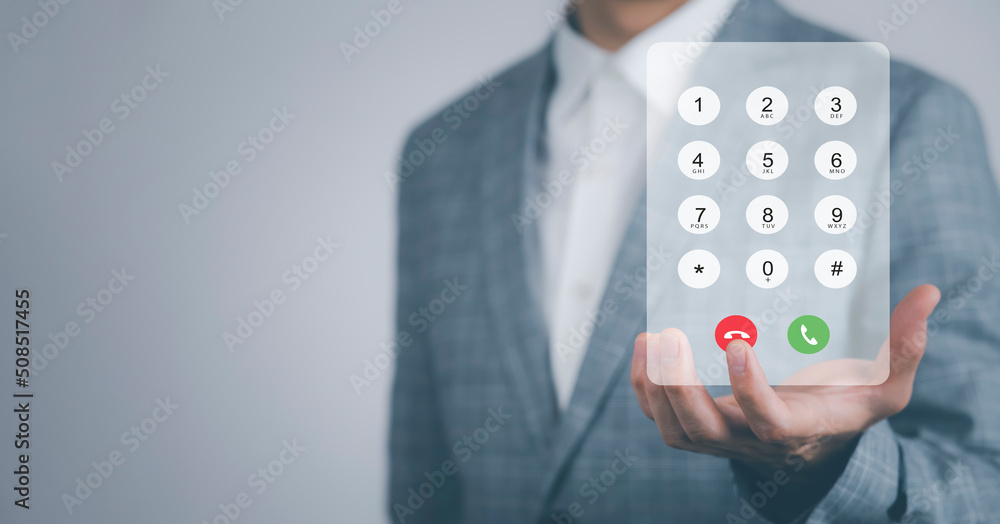 Poster dialing on virtual telephone keypad with transparent telephone buttons, businessman touch emergency 