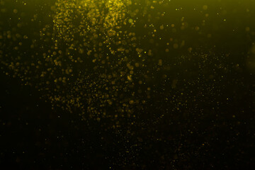 Golden sparkles on a black background. Blank for holiday, Christmas cards.