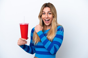 Young Uruguayan woman drinking soda isolated on white background celebrating a victory