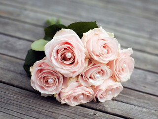 Bridal bouquet of pink roses on boardwalk