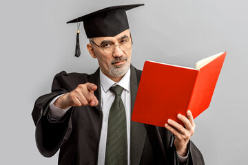 Academician, Professor, Prof is wearing a cap with Tassel and black gown. Senior educator or Doctor of Philosophy, learned man from a university or college