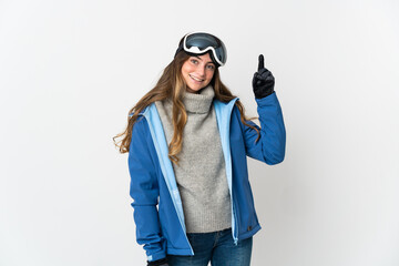 Skier girl with snowboarding glasses isolated on white background pointing up a great idea
