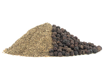 Pile of black ground pepper and peppercorns isolated on a white background