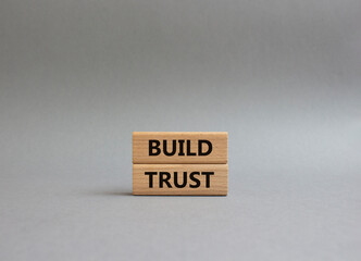 Build trust symbol. Wooden blocks with words Build trust. Beautiful grey background. Business and...