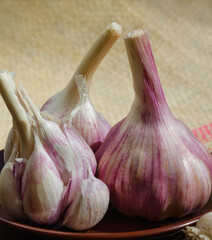 Garlic cloves in a bowl on burlap.