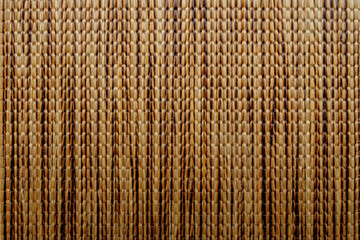 Wicker background made of natural straw. Full frame of densely woven straw pattern. Natural, natural background