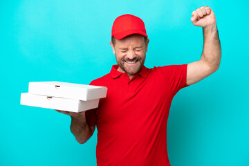 Pizza delivery man with work uniform picking up pizza boxes isolated on blue background doing...