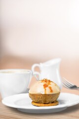 Homemade chocolate cheesecake slice in white plate on cafe background